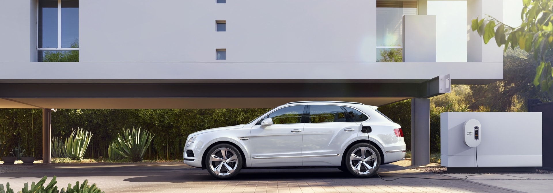 Bentayga-Hybrid-parked-outside-luxury-home
